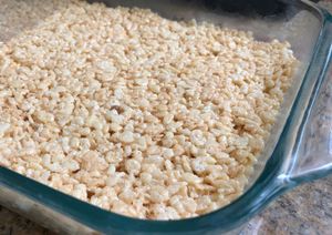 A layer of unsliced rice crispies in a pan.